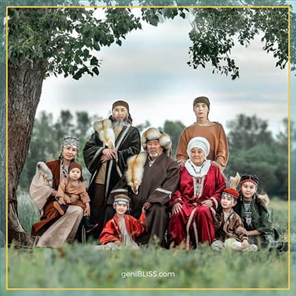 multi generational family in native dress pictured under a tree by genibliss