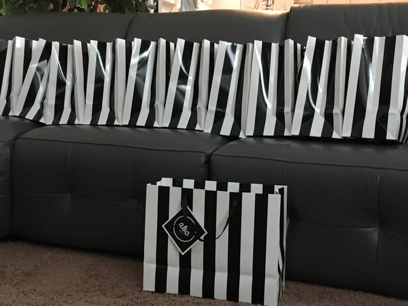 multiple black and white stripped bags of filled with keepsakes for our family reunion. one bag for each family unit.